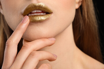 Beautiful young woman with  golden makeup, closeup