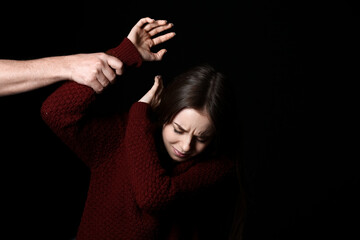 Man and his victim on dark background. Concept of harassment