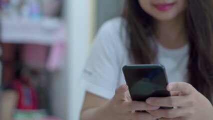 woman using smartphone in living room