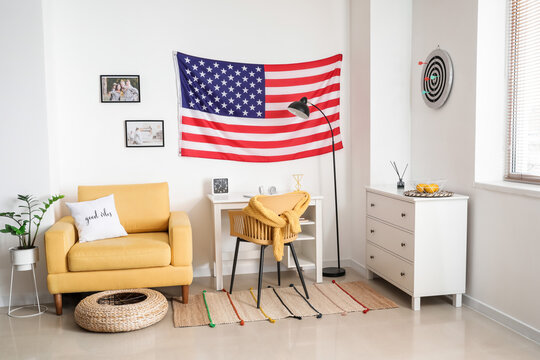 Interior of stylish room with modern workplace and USA flag