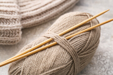 Knitting yarn and needles on grunge background, closeup