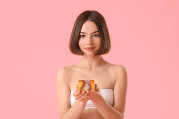 Beautiful young woman with soap on color background