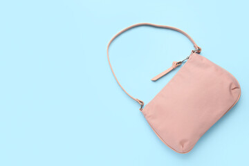 Stylish handbag on color background