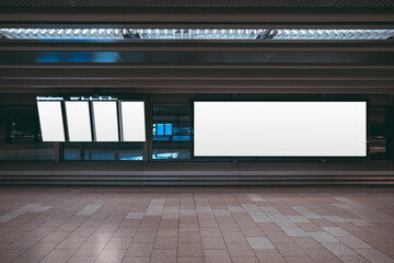 A huge rectangular empty billboard mockup in an airport departure area with vertical LCD screens...