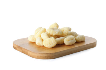 Wooden board with raw gnocchi on white background