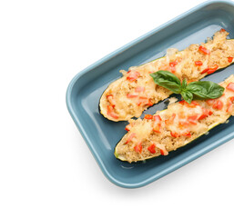 Baking dish with quinoa stuffed zucchini boats on white background, closeup