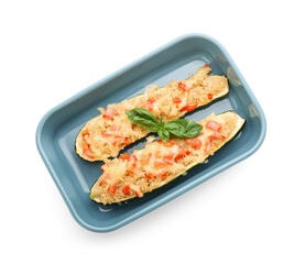 Baking dish with quinoa stuffed zucchini boats on white background