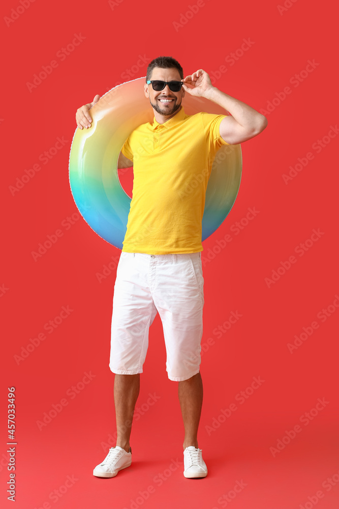 Canvas Prints young man with inflatable ring on color background