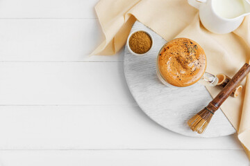Composition tasty dalgona hojicha latte on light wooden background