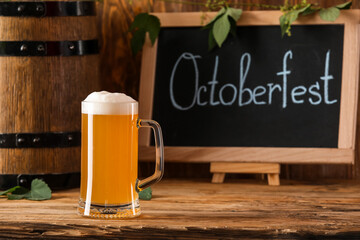 Mug of fresh beer on wooden background. Oktoberfest celebration