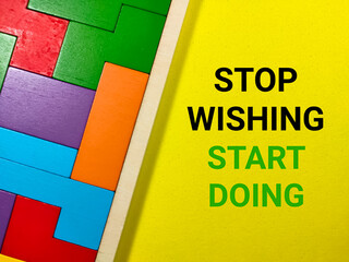 Obraz premium Business concept.Text STOP WISHING START DOING with wooden puzzle on yellow background.