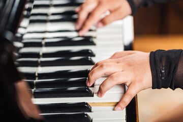 Beautiful male pianist hand on piano key