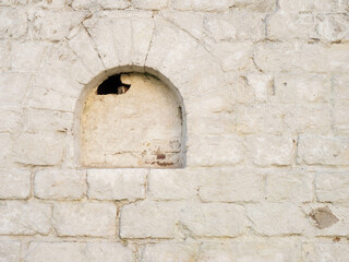 Old white brickwork. Loophole in the Kremlin wall