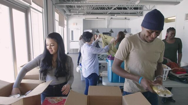 Volunteers sorting donations for charity drive in community center