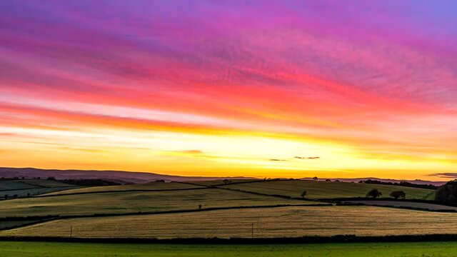 Sunset over the fields in Time Lapse Movie, Berry Pomeroy Village in Devon, England, Europe