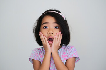 Closeup portrait of Asian little girl showing shocked face expression