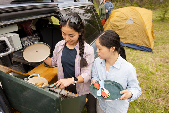 Sisters cooking in camper van