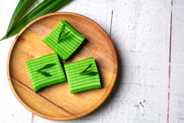 Kue lapis means layers cake, Indonesian traditional food. Made using soft rice flour pudding, it usually consists of two layers of different colors, grey and green