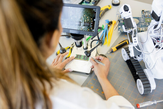 Female engineer assembling semiconductor