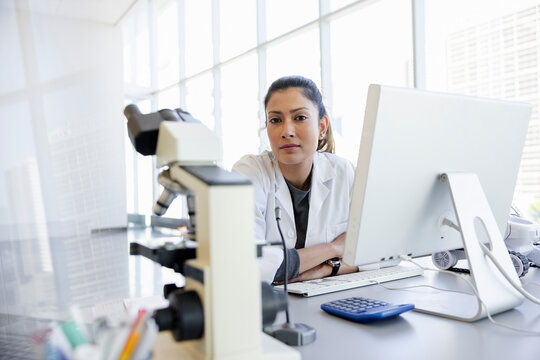 Portrait Confident Female Scientist Working At Computer In Laboratory