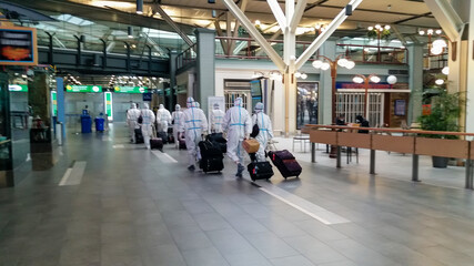 departure of passengers in protective suits at the airport