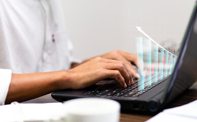 Businessman analysis data financial graph growth on laptop computer and increase sale marketing financial investment planning business in future