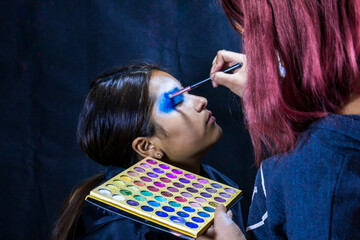 Backstage makeup. Women doing Halloween makeup, people in professional makeup artist training.