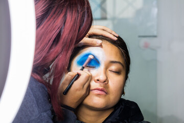 Backstage makeup. Women doing Halloween makeup, people in professional makeup artist training.