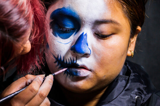 Backstage makeup. Women doing Halloween makeup, people in professional makeup artist training.