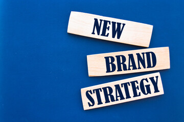 New Brand Strategy Text on Wooden Blocks on blue Background