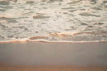 Waves hitting sand shore on a late evening. Photo taken in Asia, Thailand
