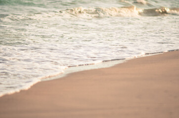 Waves hitting sand shore on a late evening. Photo taken in Asia, Thailand
