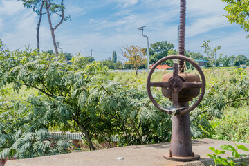 Rusted irrigation gate valve in rural countryside