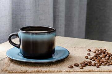 Cup of coffee on a wooden table on a gray background