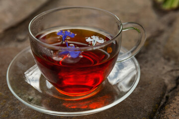 A cup of herbal tea on a wooden table. Health from nature. Close-up.
