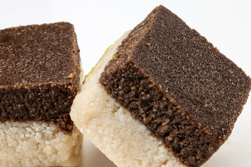 Sondesh barfi shondesh traditional indian dehydrated milk sweet colourful chocolate brown off white on white background