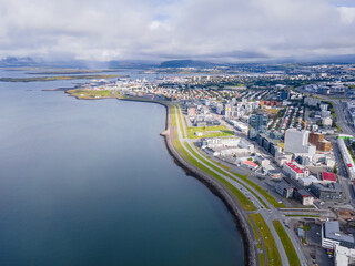 Fototapeta premium Beautiful aerial view of the City of Reykjavik, with its majestic church and colorful houses and streets in Iceland