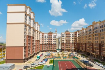 City courtyard or street with cars and playgrounds for children and walks.
