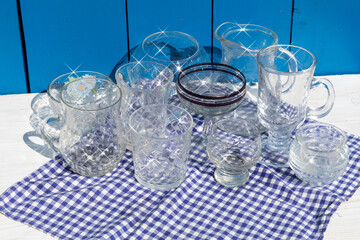 Washed, shiny glassware sits on a blue checkered napkin.