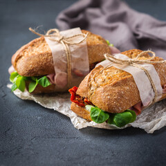 Fresh rye bread sandwich with ham, lettuce and tomato