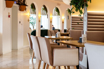 Interior of cozy luxury restaurant with original design and live plants