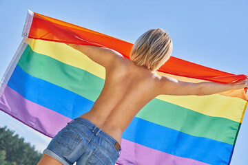 Naked woman wearing lgbt flag.