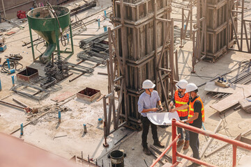 Structural engineer and foreman worker with blueprints discuss, plan inspecting for the outdoors...