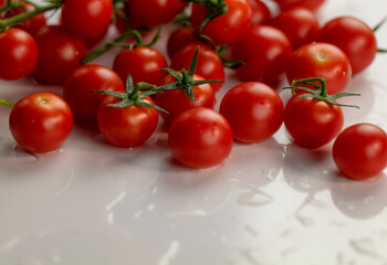 Group of cherry tomatoes on white table