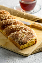cherry-vanilla strudel knife and a cup of tea on a light gray surface