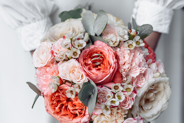 hands of young people with wedding wedding rings. wedding day details. calla flowers. spouses newlyweds groom and bride