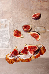 croissant with chocolate cream and gingerbread figs on vintage paper background flying food