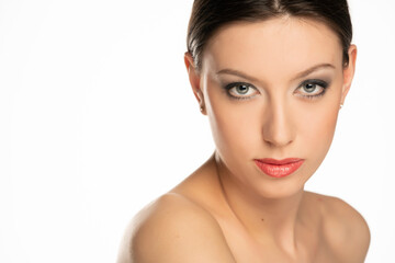 Fototapeta premium Sensual portrait of a young beautiful shirtless woman with blue eyes and makeup