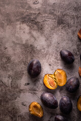 Fresh raw plums ready to be prepared on cutting board