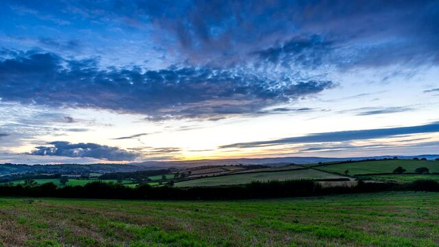 Sunset over the fields in Time Lapse Movie, Berry Pomeroy Village in Devon, England, Europe
